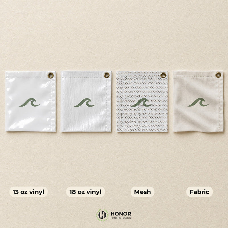 Four banner swatches side by side, labeled 13 oz vinyl, 18 oz vinyl, mesh and fabric, each with a grommet