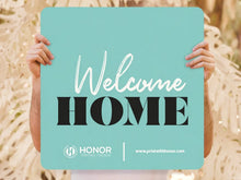 Load image into Gallery viewer, Custom Welcome Home church sign in teal, held by hand

